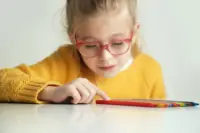 A child with glasses reading