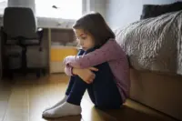 A child by her bed upset.