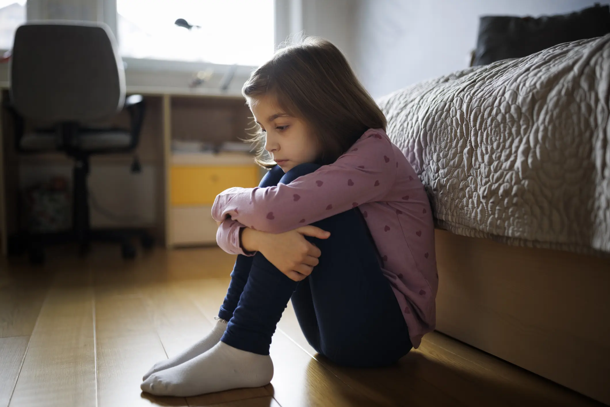 A child by her bed upset.